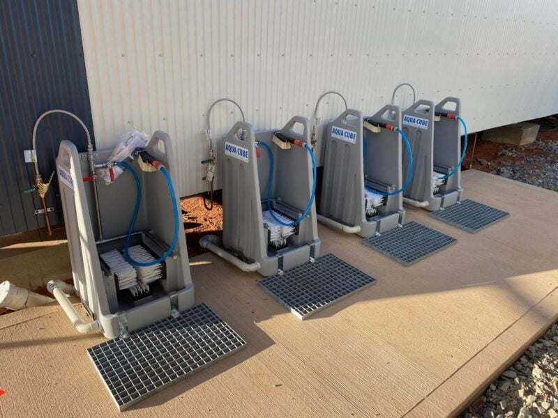 A line of Aqua Cube Stations with the metal grate attachment. Aqua Cube is the leading boot cleaning station.